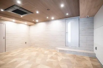 a large room with wooden walls and a large mirror at ASMACi MAISON\u4e21\u56fd I in Tokyo