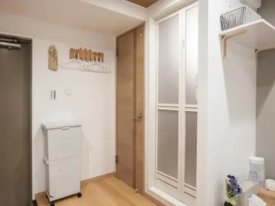 a room with a closet and a refrigerator and a door at \u685c\u306e\u5ddd72 \u521d\u53f0\u99c55\u5206 2-4\u4eba\u4e285 minute from Hatsudai 2-4 people in Tokyo