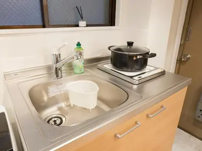 a kitchen sink with a pot on a stove at \u685c\u306e\u5ddd72 \u521d\u53f0\u99c55\u5206 2-4\u4eba\u4e285 minute from Hatsudai 2-4 people in Tokyo