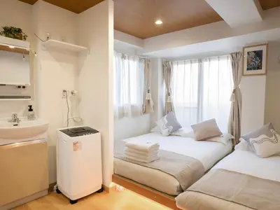 a room with two beds and a sink and a window at \u685c\u306e\u5ddd73 \u521d\u53f0\u99c55\u5206 2-4\u4eba\u4e285 minute from Hatsudai 2-4 people in Tokyo