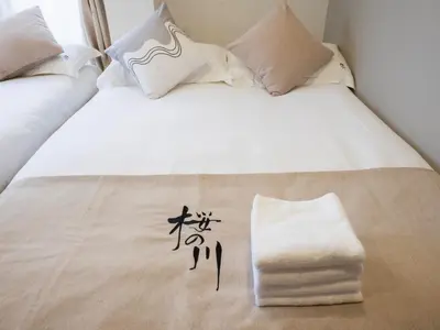 a white bed with chinese writing on it at \u685c\u306e\u5ddd73 \u521d\u53f0\u99c55\u5206 2-4\u4eba\u4e285 minute from Hatsudai 2-4 people in Tokyo