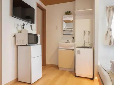 a small kitchen with a microwave and a sink at \u685c\u306e\u5ddd73 \u521d\u53f0\u99c55\u5206 2-4\u4eba\u4e285 minute from Hatsudai 2-4 people in Tokyo