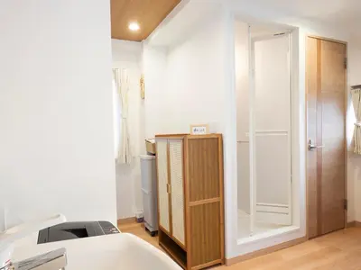 a room with a bed and a mirror and a closet at \u685c\u306e\u5ddd74 \u521d\u53f0\u99c55\u5206 2\u4eba\u4e285 minute from Hatsudai 2 people in Tokyo