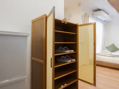 a room with a wooden closet with shoes in it at \u685c\u306e\u5ddd74 \u521d\u53f0\u99c55\u5206 2\u4eba\u4e285 minute from Hatsudai 2 people in Tokyo
