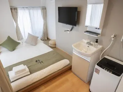 a small bedroom with a bed and a sink at \u685c\u306e\u5ddd74 \u521d\u53f0\u99c55\u5206 2\u4eba\u4e285 minute from Hatsudai 2 people in Tokyo