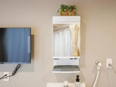 a room with a tv and a mirror at \u685c\u306e\u5ddd74 \u521d\u53f0\u99c55\u5206 2\u4eba\u4e285 minute from Hatsudai 2 people in Tokyo