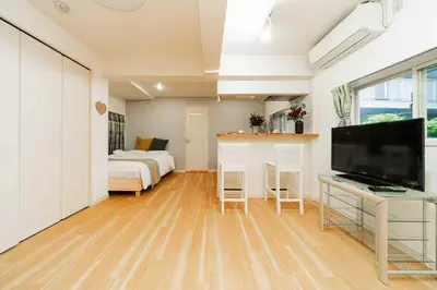 a bedroom with a bed and a television in a room at Nine Lane Nippori II in Tokyo