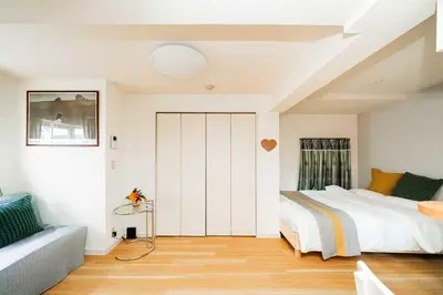 a bedroom with a bed and a couch at Nine Lane Nippori II in Tokyo
