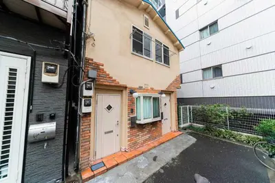 a brick house with a door and a building at Nine Lane Nippori II in Tokyo