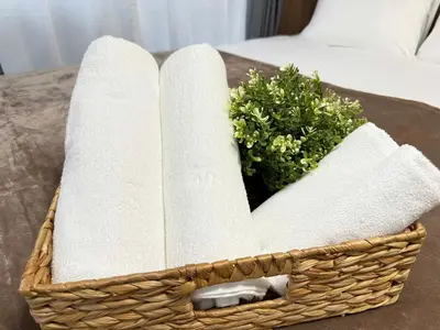 a basket with towels and a plant on a table at Shinjuku Area 302 Shinjuku Apartment in Tokyo