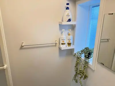 a bathroom with two shelves on the wall and a mirror at Shinjuku Area 302 Shinjuku Apartment in Tokyo