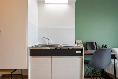 a kitchen with a sink and a desk at CraftFlat Komagome 503, a compact studio at excellent location in Tokyo