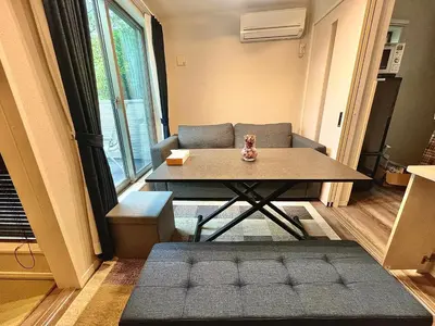 a living room with a table and a couch at \u5357\u516c\u5712\u30b9\u30ab\u30a4\u30d3\u30e5\u30fc in Tokyo
