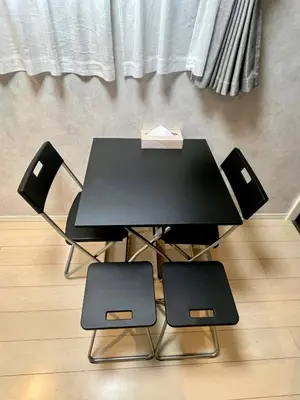 a black table and two chairs in a room at \u5357\u516c\u5712\u30b9\u30ab\u30a4\u30d3\u30e5\u30fc in Tokyo