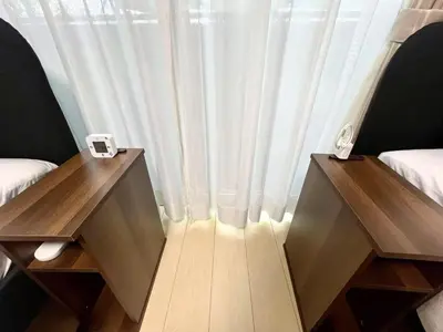 a room with two tables and a window with curtains at \u5357\u516c\u5712\u30b9\u30ab\u30a4\u30d3\u30e5\u30fc in Tokyo