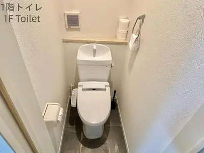 a small bathroom with a white toilet in a stall at \u5357\u516c\u5712\u30b9\u30ab\u30a4\u30d3\u30e5\u30fc in Tokyo