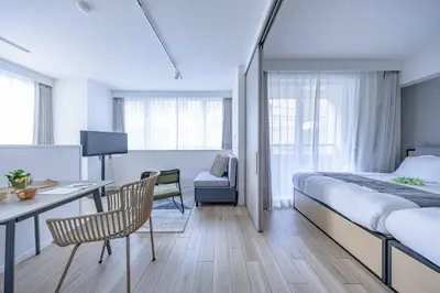 a hotel room with a bed and a desk and chair at \u30b7\u30c6\u30a3\u30c6\u30e9\u30b9\u8d64\u5742 in Tokyo
