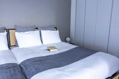 a large bed with a book on top of it at \u30b7\u30c6\u30a3\u30c6\u30e9\u30b9\u8d64\u5742 in Tokyo