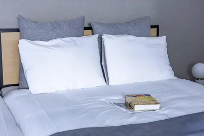 a book sitting on top of a bed with pillows at \u30b7\u30c6\u30a3\u30c6\u30e9\u30b9\u8d64\u5742 in Tokyo