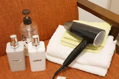 a blow dryer sitting on a chair with towels at Comore Villa 1F in Tokyo
