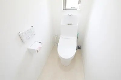 a white toilet in a white bathroom with a window at Comore Villa 1F in Tokyo