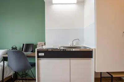 a kitchen with a sink and a desk at CraftFlat Komagome 504, a compact studio at excellent location in Tokyo