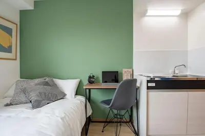 a bedroom with a bed and a desk and a sink at CraftFlat Komagome 504, a compact studio at excellent location in Tokyo