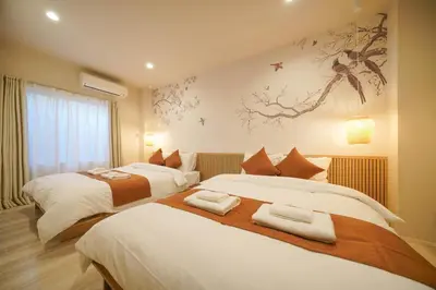 a bedroom with two beds and a painting on the wall at LinksHotel\u4e0a\u91ce in Tokyo