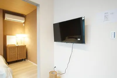 a room with a flat screen tv on a wall at LinksHotel\u4e0a\u91ce in Tokyo