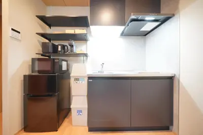 a kitchen with a sink and a refrigerator at LinksHotel\u4e0a\u91ce in Tokyo