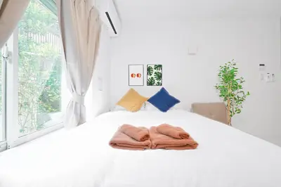 a bedroom with a bed with a towel on it at Vivere in Tokyo