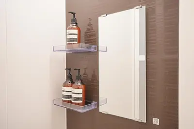 a medicine cabinet with two bottles on the wall at Vivere in Tokyo