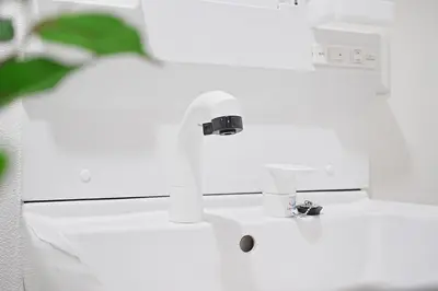 a bathroom with a white sink with a faucet at Vivere in Tokyo