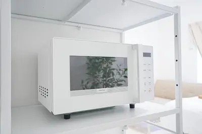 a white computer monitor on a shelf in a room at Vivere in Tokyo