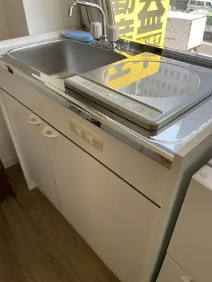 a kitchen counter with a sink and a dishwasher at Yotsuya, 10 seconds from Yotsuya Sanchome Station, in the heart of Shinjuku in Tokyo