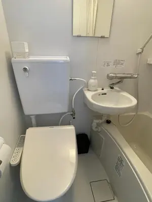 a small bathroom with a toilet and a sink at Yotsuya, 10 seconds from Yotsuya Sanchome Station, in the heart of Shinjuku in Tokyo