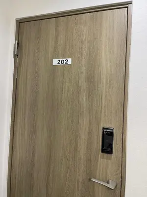 a wooden door with a sign on it at Yotsuya, 10 seconds from Yotsuya Sanchome Station, in the heart of Shinjuku in Tokyo