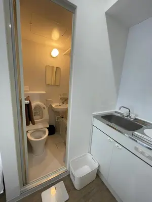 a small bathroom with a toilet and a sink at Yotsuya, 10 seconds from Yotsuya Sanchome Station, in the heart of Shinjuku in Tokyo