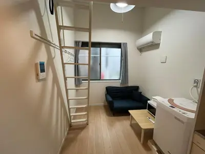 a small room with a staircase and a couch at Shinjuku 5 min, Nakano station 1 min walk, 101 in Tokyo