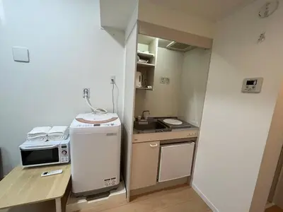 a small kitchen with a sink and a microwave at Shinjuku 5 min, Nakano station 1 min walk, 101 in Tokyo