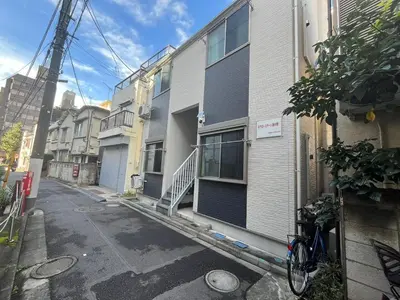 an empty street with a building and a bike parked outside at Shinjuku 5 min, Nakano station 1 min walk, 101 in Tokyo