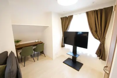 a living room with a flat screen tv on a wall at 1 stop to Ikebukuro 3 min walk from station in Tokyo