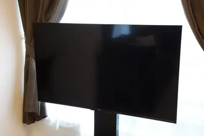 a flat screen tv on a stand next to a window at 1 stop to Ikebukuro 3 min walk from station in Tokyo