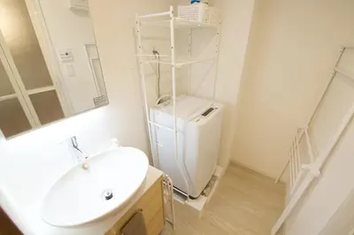 a white bathroom with a sink and a toilet at 1 stop to Ikebukuro 3 min walk from station in Tokyo
