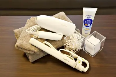 a table with two electric toothbrushes and a bottle of toothpaste at 1 stop to Ikebukuro 3 min walk from station in Tokyo