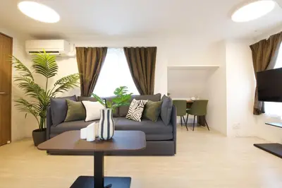 a living room with a couch and a table at 1 stop to Ikebukuro 3 min walk from station in Tokyo