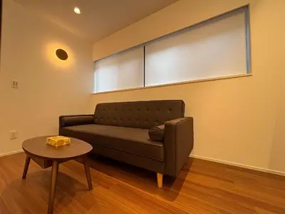 a living room with a couch and a table at PRISM Inn Kagurazaka in Tokyo