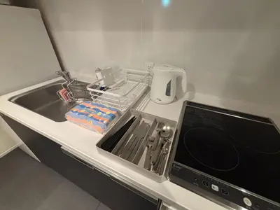 a kitchen counter with a sink and a dishwasher at PRISM Inn Kagurazaka in Tokyo