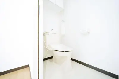 a white bathroom with a toilet in a room at Nine Lane Omori in Tokyo