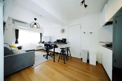 a living room with a couch and a table at Nine Lane Omori in Tokyo
